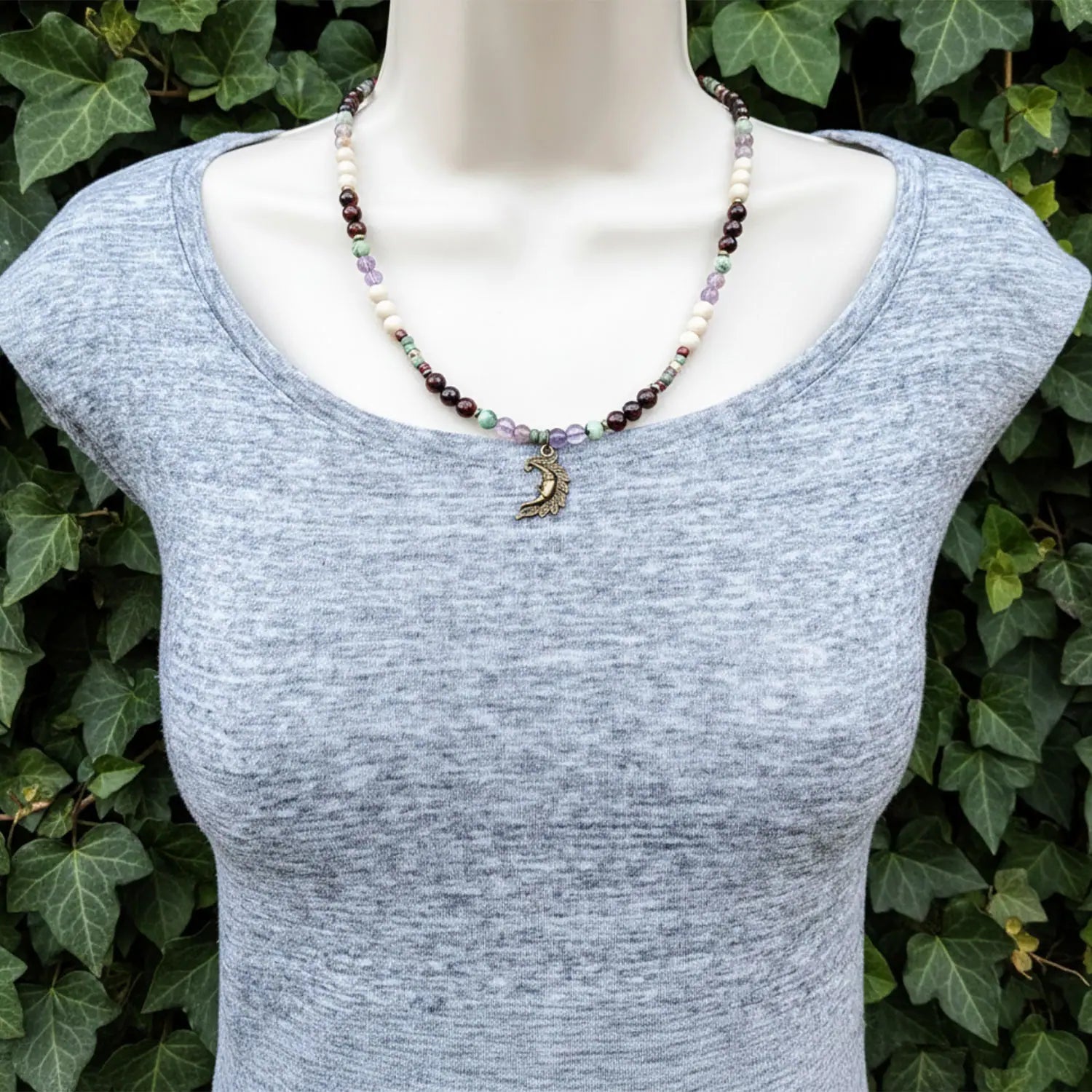 Modeled on a mannequin a crescent moon necklace.
