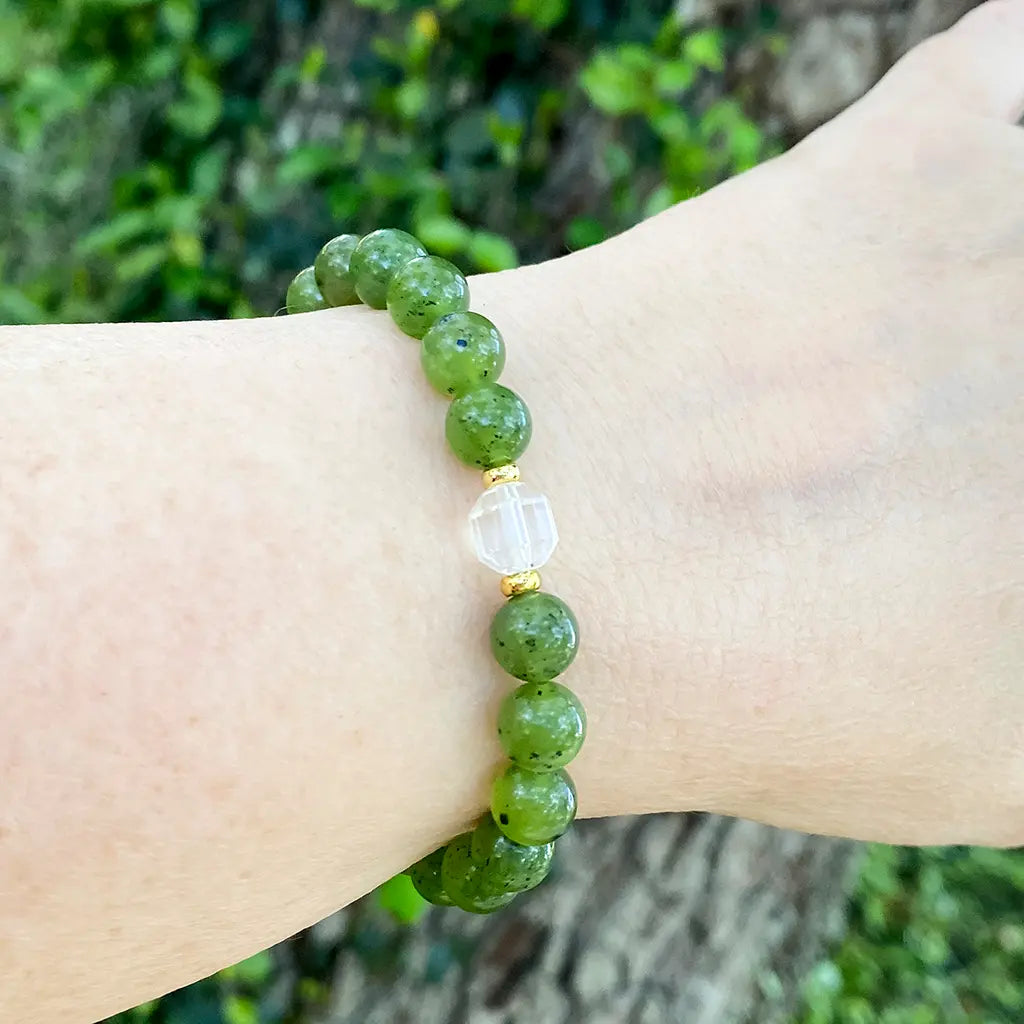 a green Nephrite Jade beaded bracelet on a woman's wrist