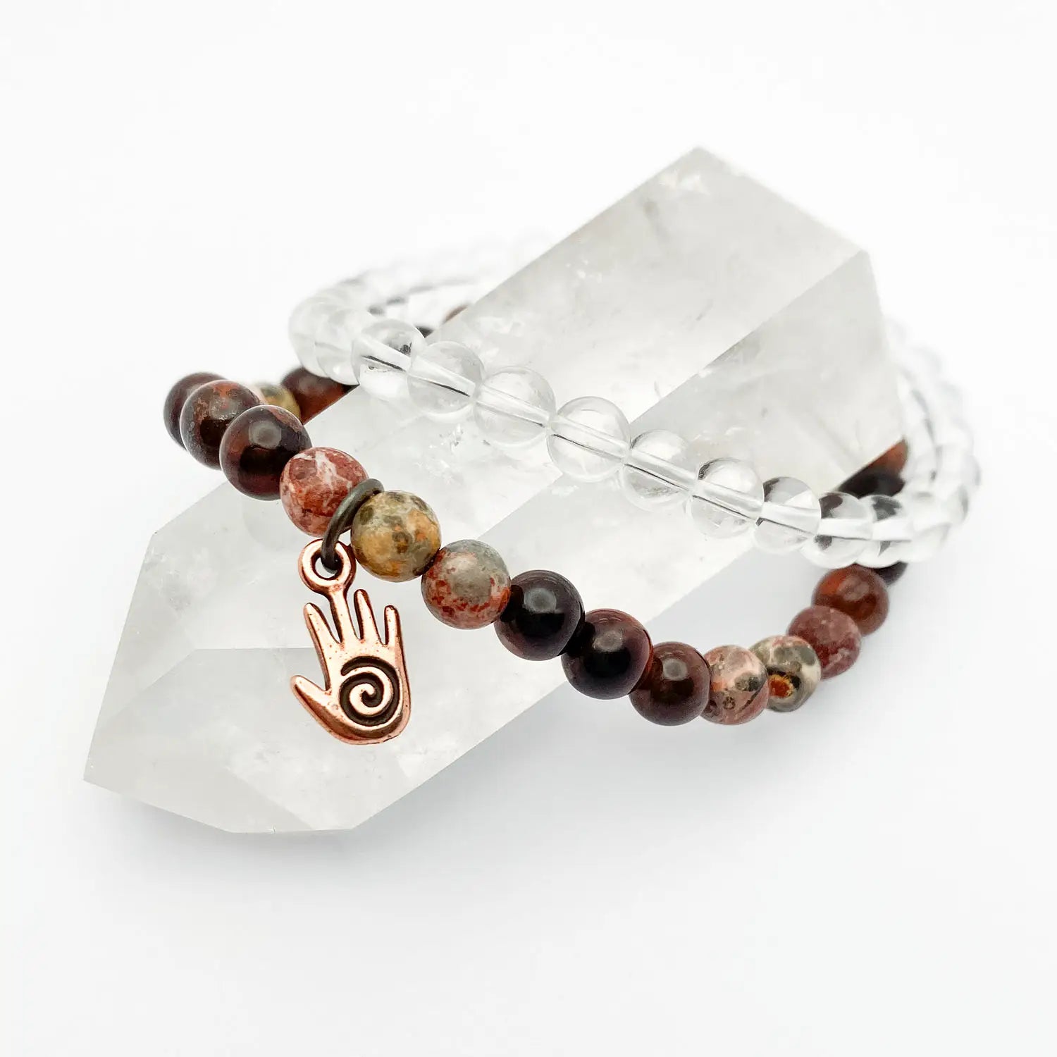Beaded bracelet with a hand and spiral charm on a crystal prism