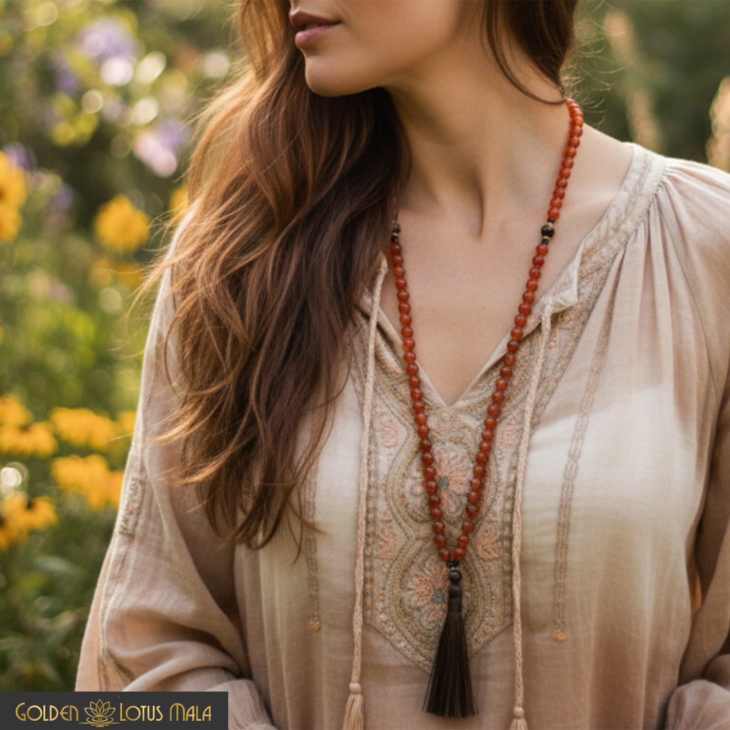 Woman wearing a carnelian mala necklace.