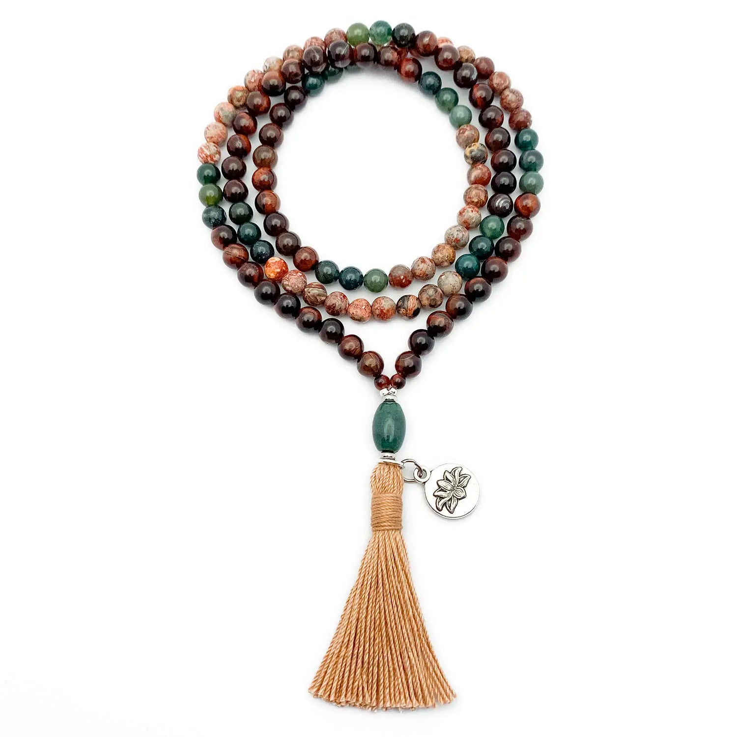 Beaded mala necklace with tassel and pendant on a white background