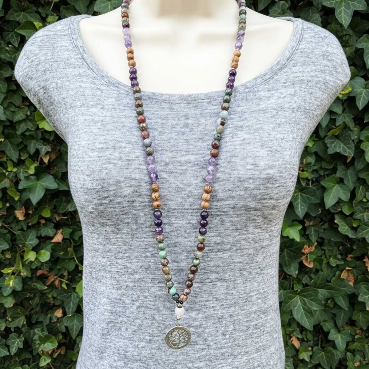 Long mala necklace on a mannequin.