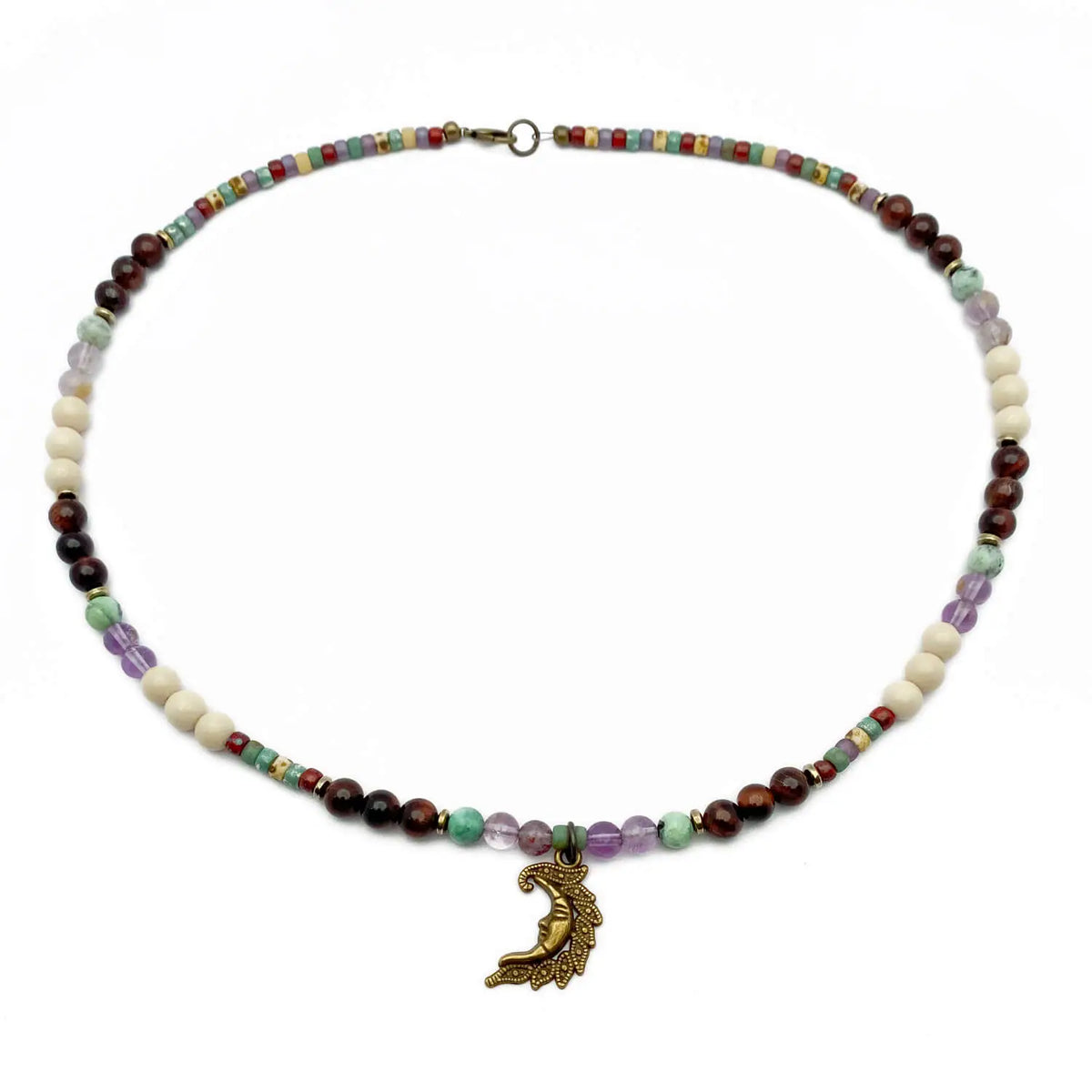 Crescent moon necklace with quartz, fossil, and tiger eye beads.