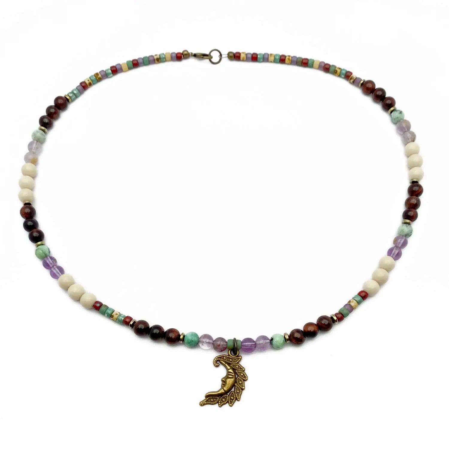 Crescent moon necklace with quartz, fossil, and tiger eye beads.