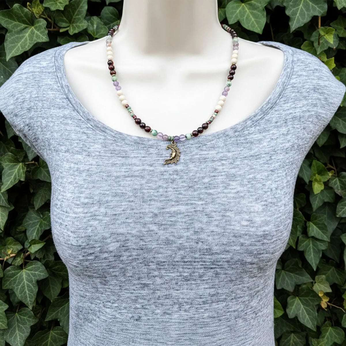 Modeled on a mannequin a crescent moon necklace.