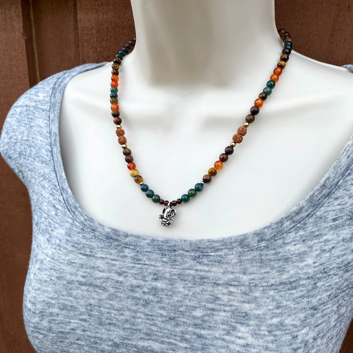 Multicolored beaded necklace on a mannequin with a plain background