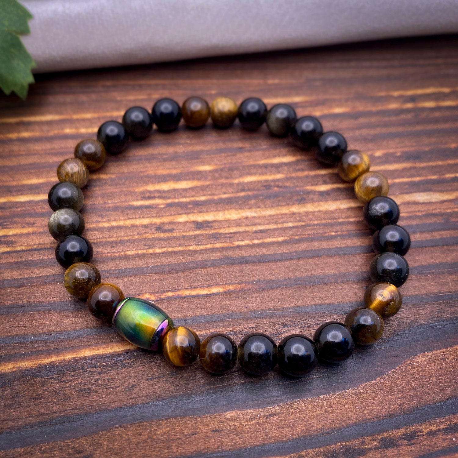 Beaded bracelet with a large colorful "mood" bead on a wooden surface