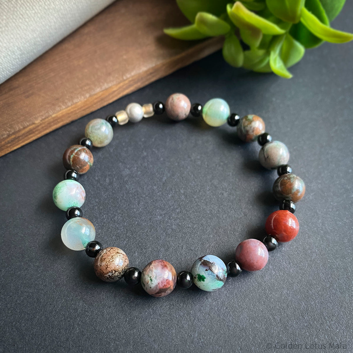 Beaded bracelet with multicolored beads on a dark surface