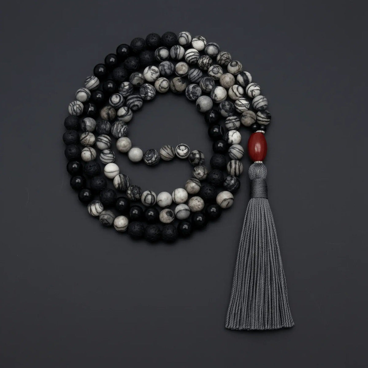 Beaded mala necklace with a tassel on a dark background