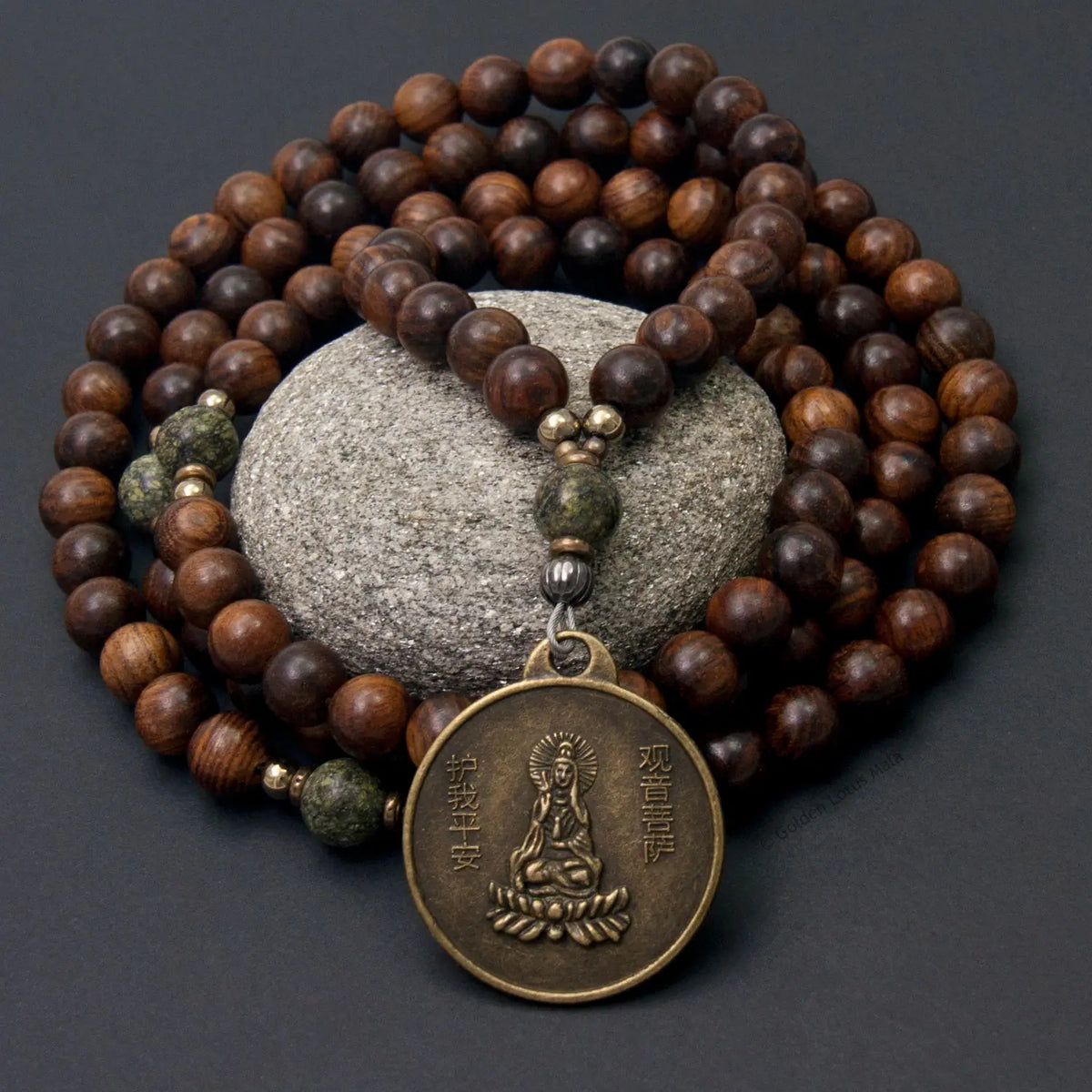 Guan Yin Mala made with Rosewood sets on a black background.